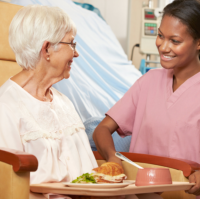 caregiver assisting patient in eating