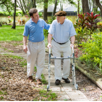 caregiver assisting patient in walking